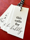 Cotton letterpress champagne gift tags saying, "This Calls for Bubbly"