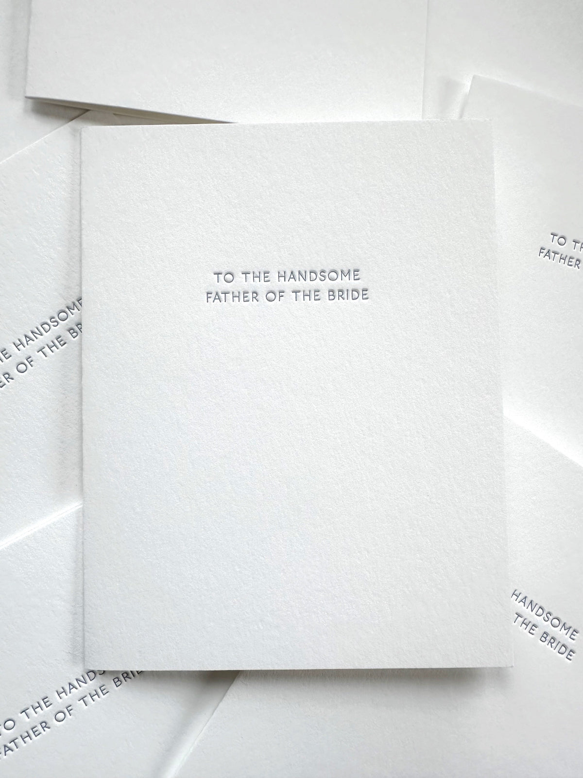 White card with text 'To the handsome father of the bride' on a white background