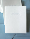 White card with text 'To the handsome father of the groom' on a blue envelope.