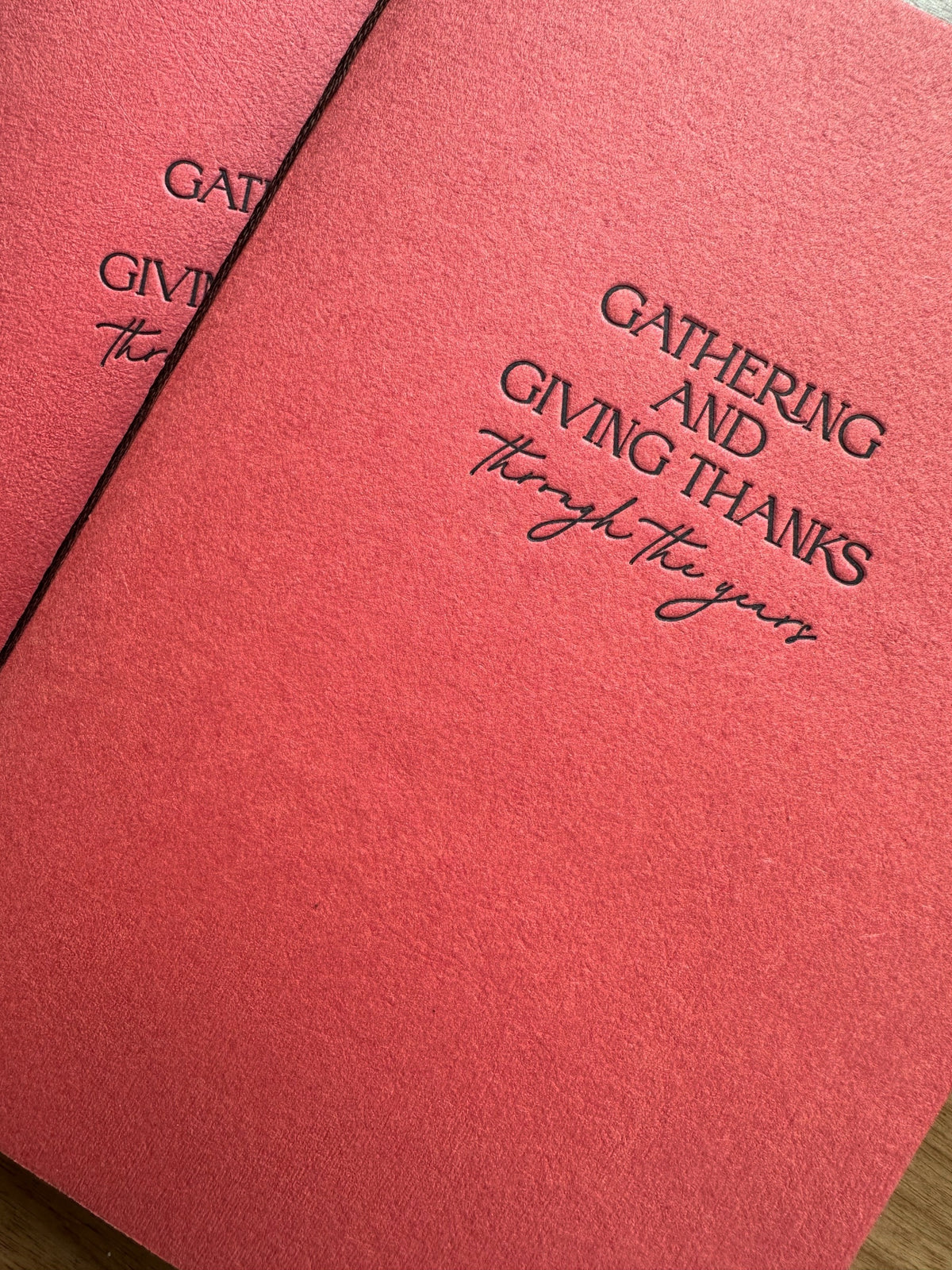 Hand-bound Thanksgiving memory journal with -persimmon handmade paper cover, letterpress chocolate ink title, and blank unlined pages inside