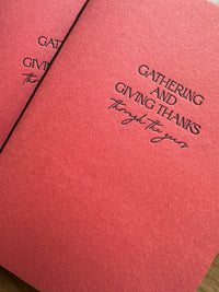 Hand-bound Thanksgiving memory journal with -persimmon handmade paper cover, letterpress chocolate ink title, and blank unlined pages inside
