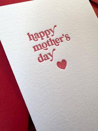 Close-up of letterpress impression on Mother’s Day card with red heart.