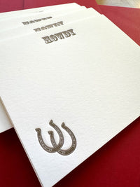 Western-style letterpress card featuring horseshoe and Howdy message in brown ink