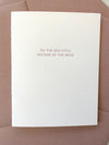 White card with 'To the beautiful mother of the bride' text on a rose envelope