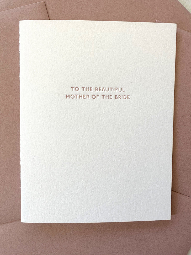 White card with 'To the beautiful mother of the bride' text on a rose envelope