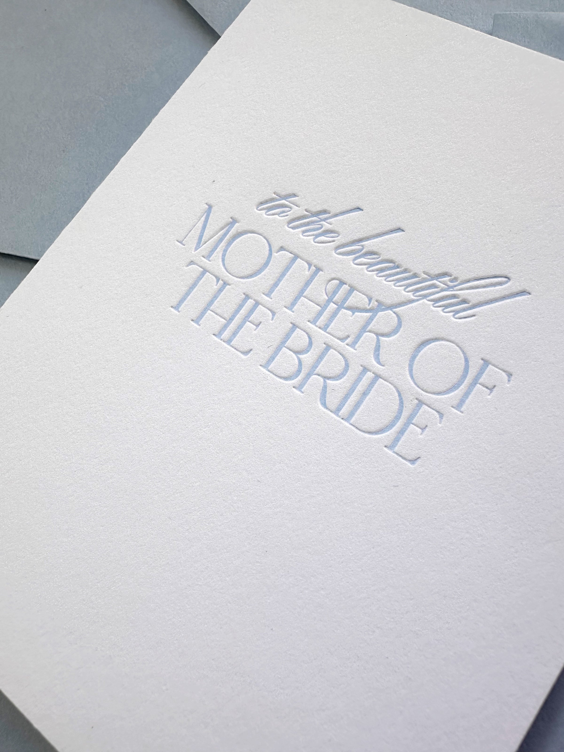 Close up of a letterpress card "To the Beautiful Mother of the Bride" for weddings.