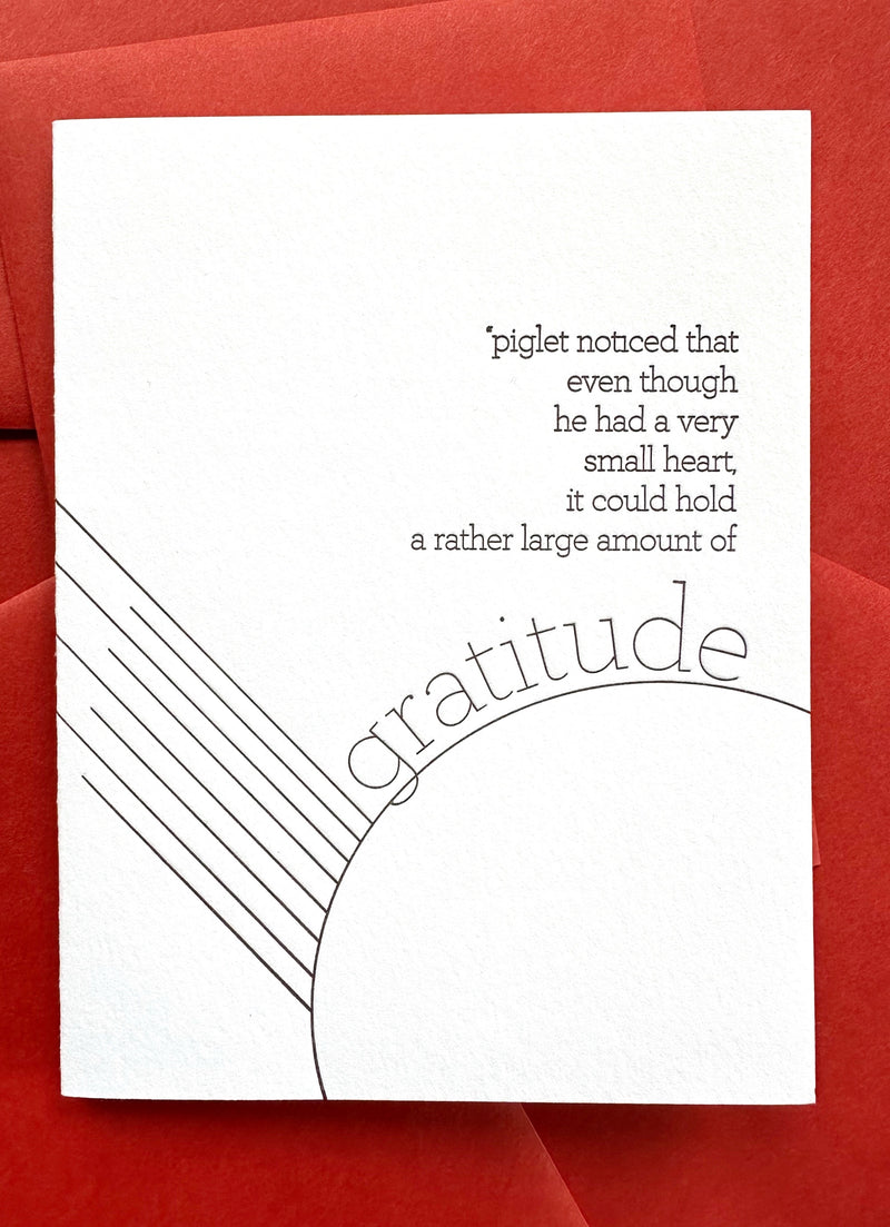 Letterpress greeting card with Piglet gratitude quote in chocolate ink on bright white cotton cardstock, paired with a persimmon-colored envelope