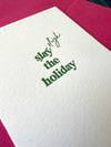 Close-up of letterpress detail on “Slay (Sleigh) the Holiday!” card in green ink – crisp, textured print on white cotton paper