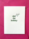 Letterpress holiday card with green “Slay (Sleigh) the Holiday!” text, paired with a pink envelope – modern and festive Christmas card