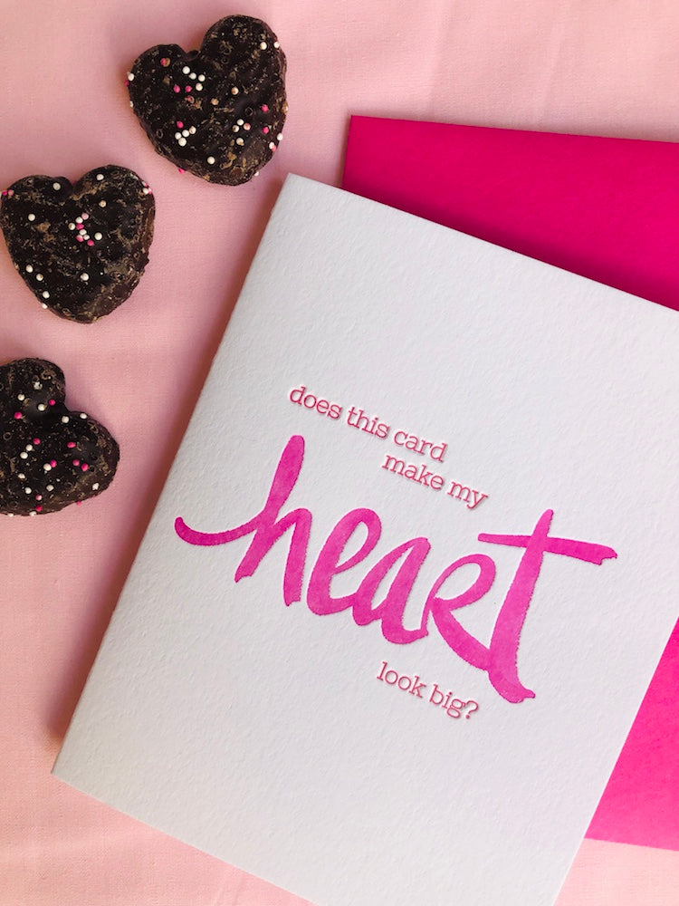 Humorous letterpress card for Valentine's Day, a wedding or anniversary saying, "Does this card make my heart look big?" featuring unique hand lettering. 